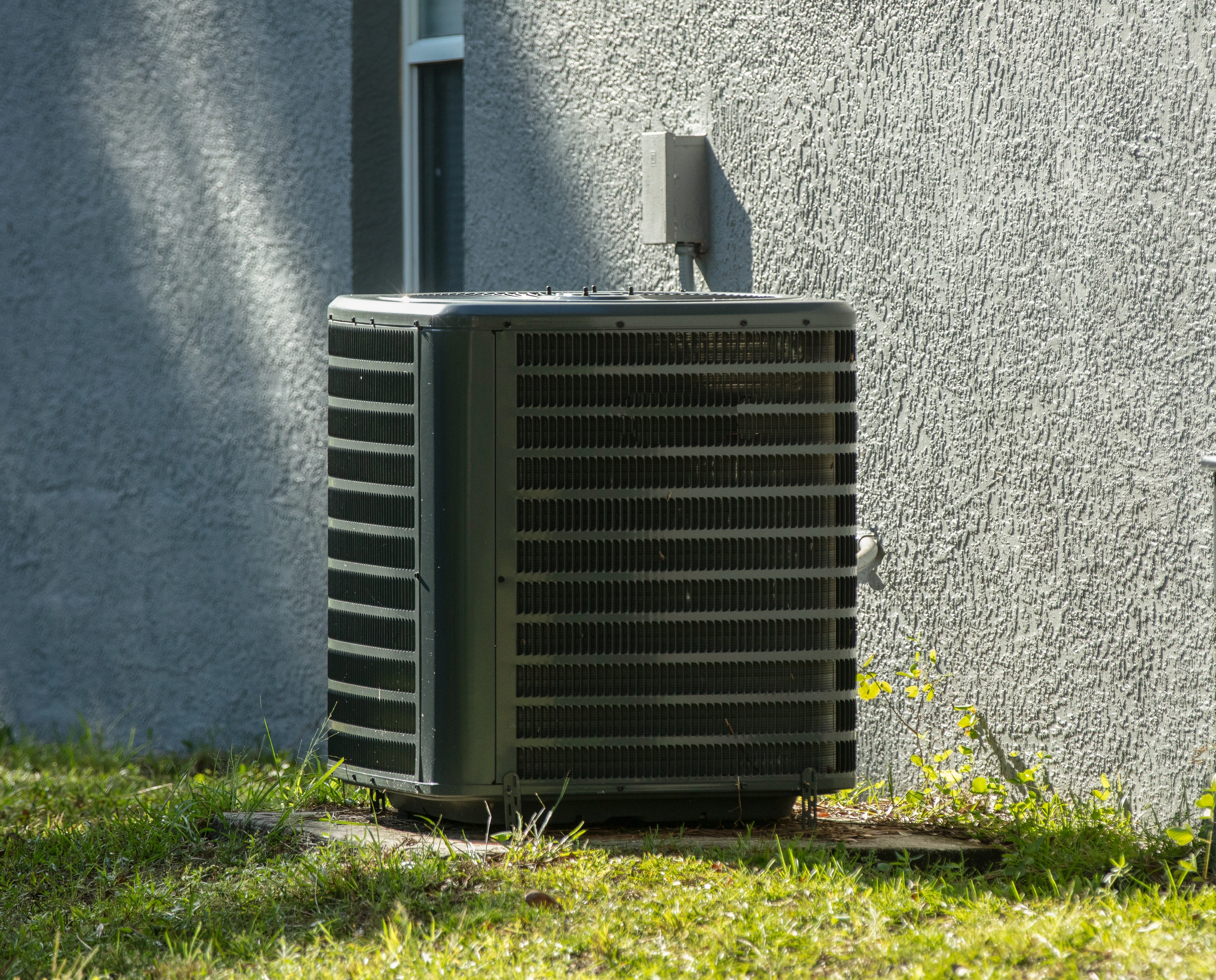 An outdoor HVAC unit in Nashville receiving professional services from Professional Heating and Cooling.